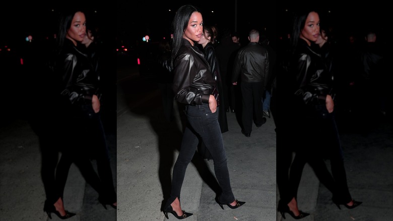 Laura Harrier wearing skinny jeans and a leather jacket during Milan Fashion Week in February 2026