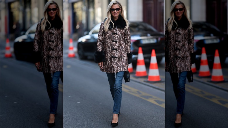 Nicky Hilton wearing skinny jeans and a deer-print jacket during Paris Fashion Week in October 2026