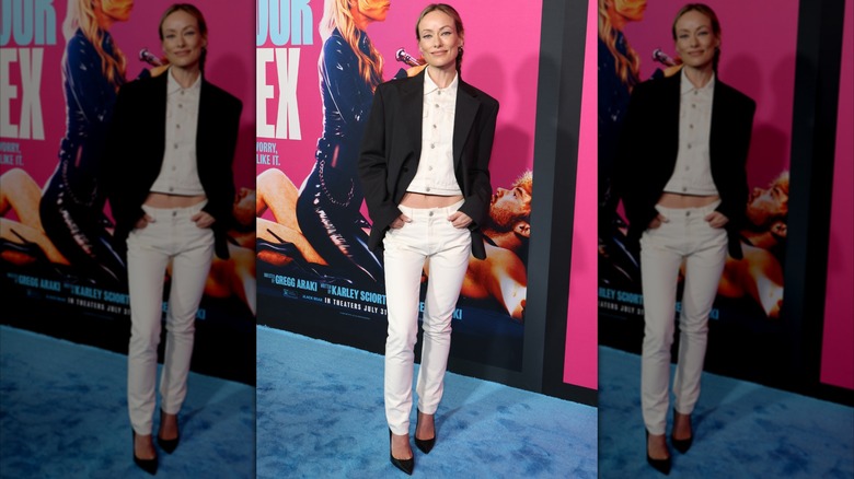 Olivia Wilde wearing white skinny jeans and a black blazer at the "I Want Your Sex" premiere in July 2026