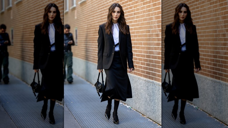 A woman with a black skirt and a black blazer