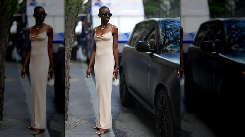 A woman wearing a cream slip dress