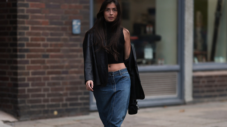 A woman wearing a denim maxi skirt