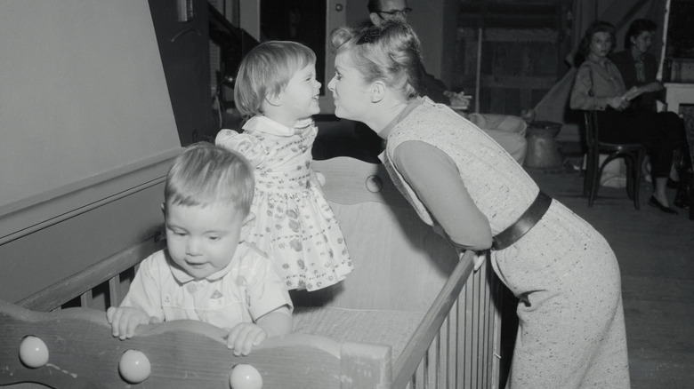 Debbie Reynolds playing with daughter Carrie, age 2-1/2, on the 20th Century Fox set of Say One for Me 1959