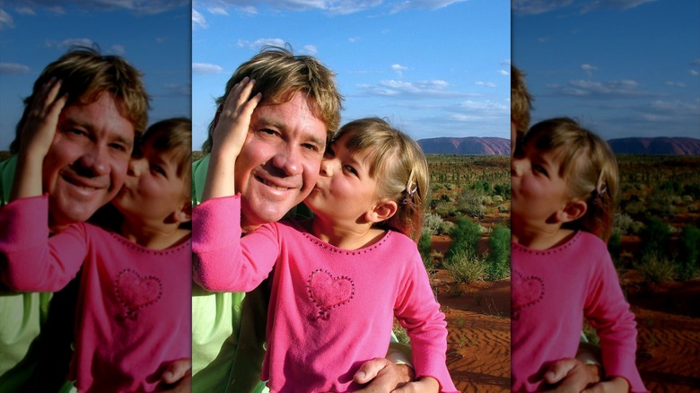 Bindi Irwin kissing Steve Irwin on his face in front of Uluru