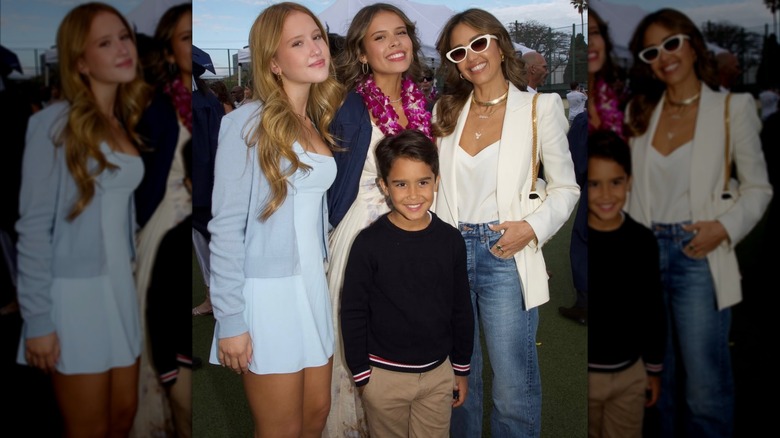 Jessica Alba in jeans and a white blazer poses with her daughters Honor and Haven and son Hayes.