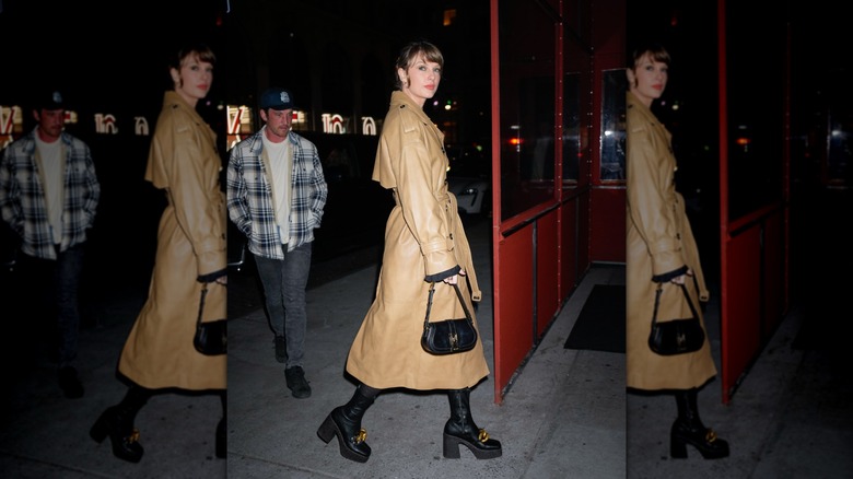 Taylor Swift wearing a tan trench with platform boots
