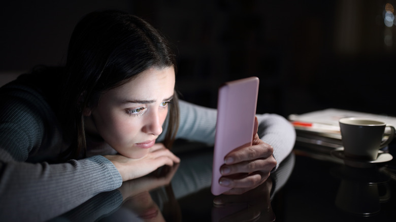 sad woman texting 