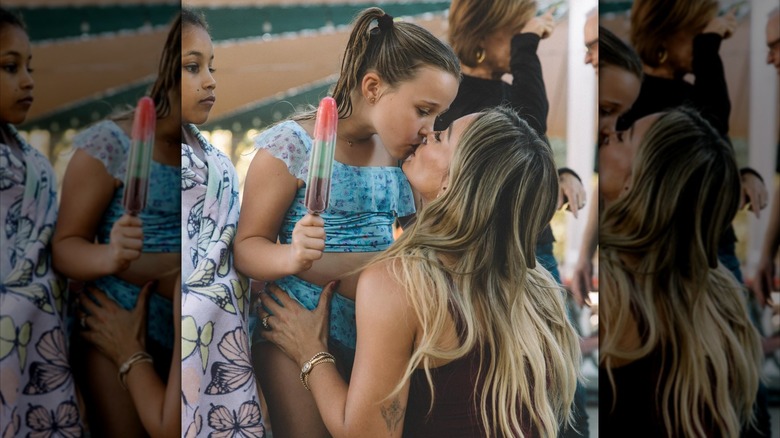 Hilary Duff wears her long blond hair down while kissing daughter Banks at her 7th birthday party.in 2026.