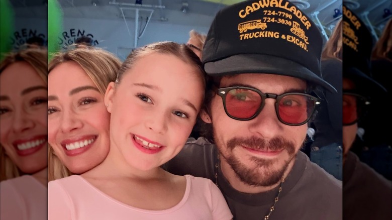 Hilary Duff and husband Matthew Koma pose with daughter Banks in her pink leotard after a dance performance in 2026.
