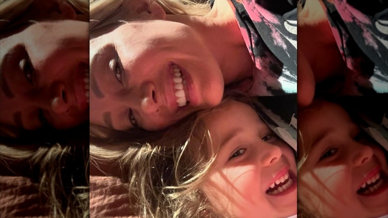 Hilary Duff and her daughter Banks cuddle with their hair down and heads together on a pillow before bedtime.