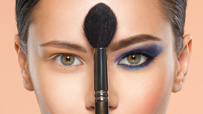 Makeup brush and woman