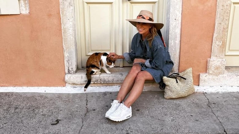 Cheryl Hines posing in Greece in a denim dress