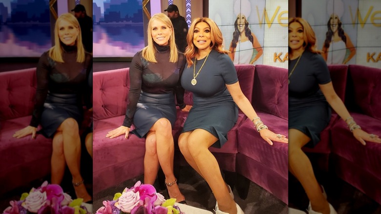 Cheryl Hines and Wendy Williams posing on the couch