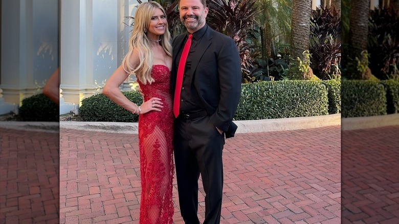 Christina Haack posing in a red dress with Christopher Larocca