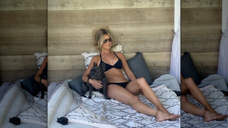 Christina Haack posing in a bikini with a French bulldog