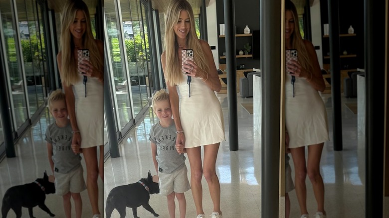 Christina Haack posing in a minidress with her son