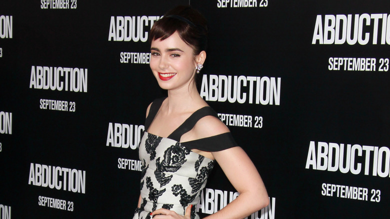 Lily Collins wearing a micro fringe and red lipstick