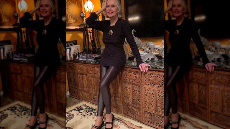 Tippi Hedren strikes a pose in leather leggings and a mini dress