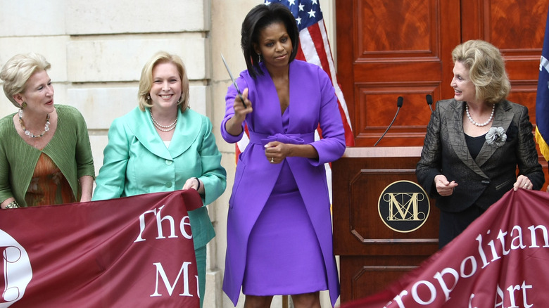Michelle Obama in 2009 cutting a ribbon