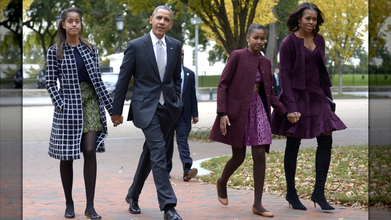 Michelle Obama in 2013 in a purple outfit with boots