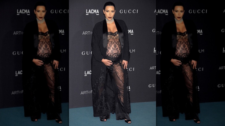 Kim Kardashian in a sheer jumpsuit that shows off her stomach