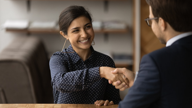 woman shaking job interviewer's hand