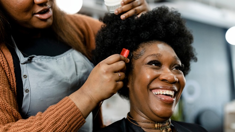 woman getting baby hairs brushed