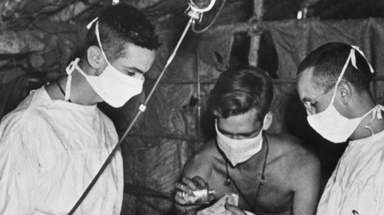 surgeons gathering around surgery table