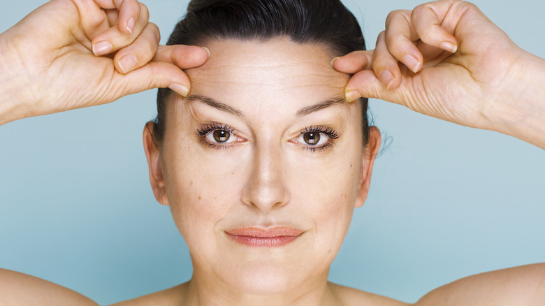 woman lifting eyebrows