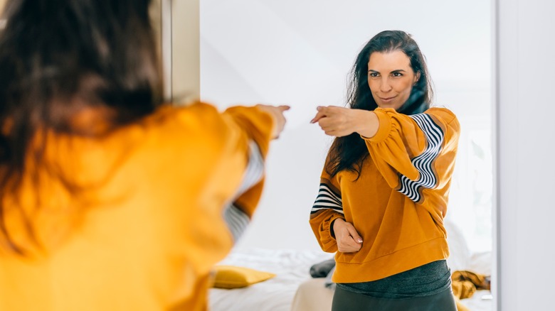 Smiling woman looking in mirror