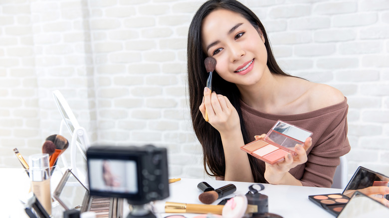 woman applying makeup