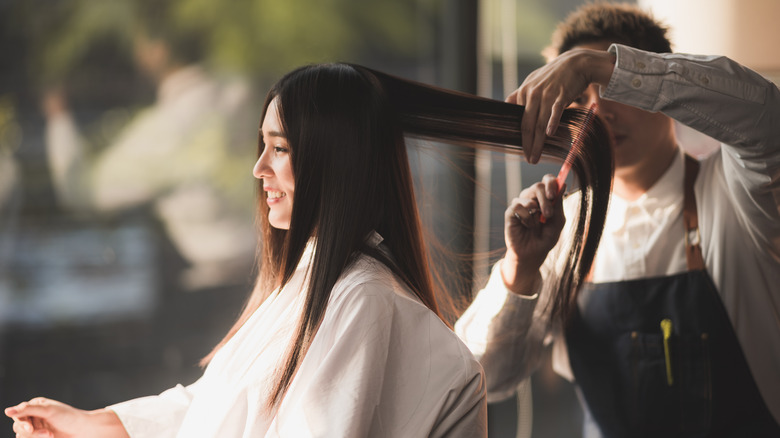 A woman getting her hair cut