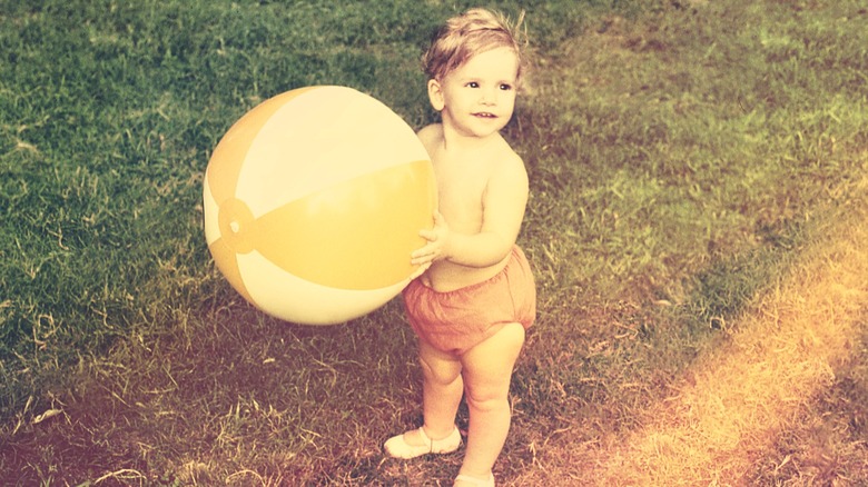 A baby boy playing outside in the 1970s