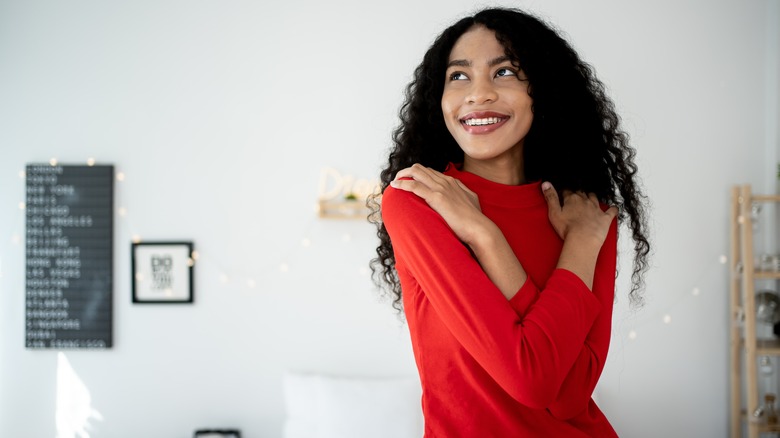 Woman hugging herself 