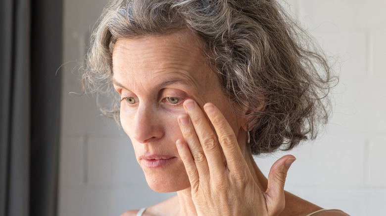 Woman touching her eyes