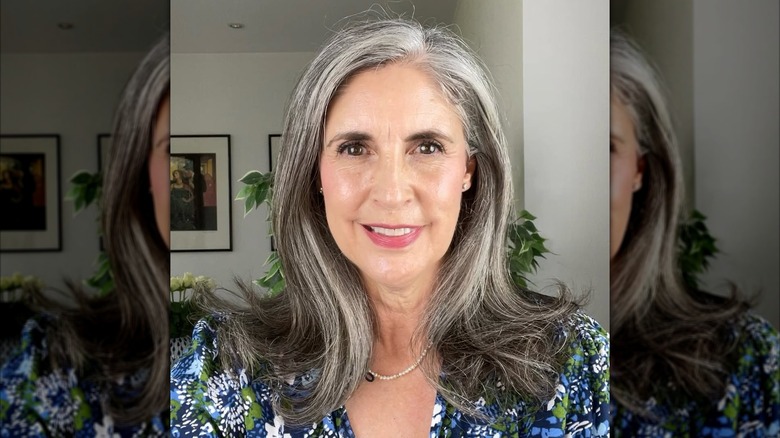 A woman with a side parted gray hairstyle.