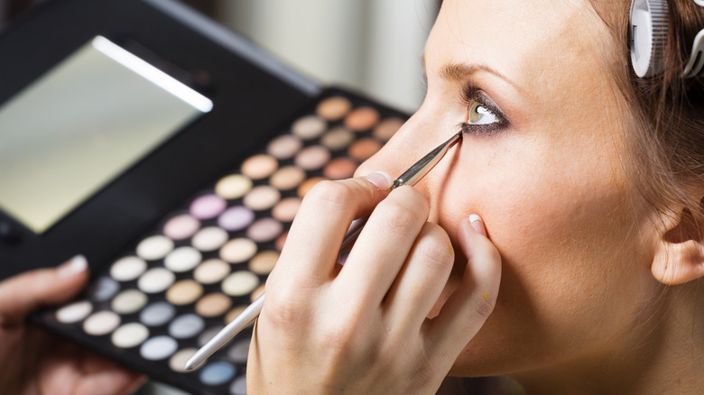 A woman getting her makeup done