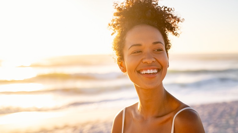 woman curly hair enjoying summer