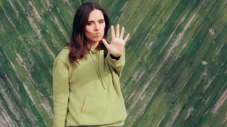 woman with hand up