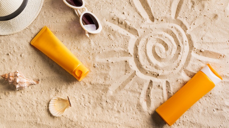 Sandy beach with product bottles