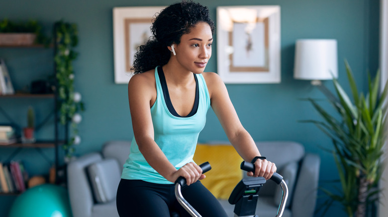 Woman cycling in home gym