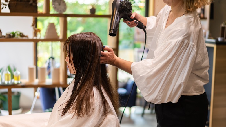 Woman getting hair styled