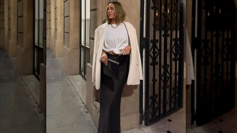 Woman pairing crop top, maxi skirt