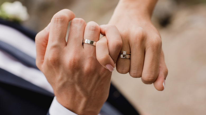 Bride and groom hands linked