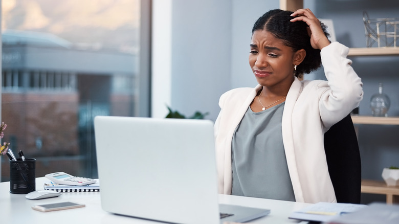 woman scratching head