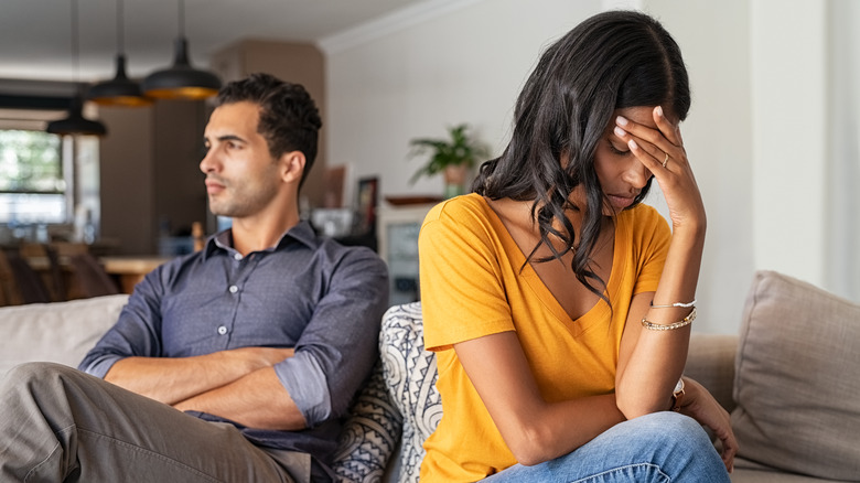 Couple looking annoyed at each other