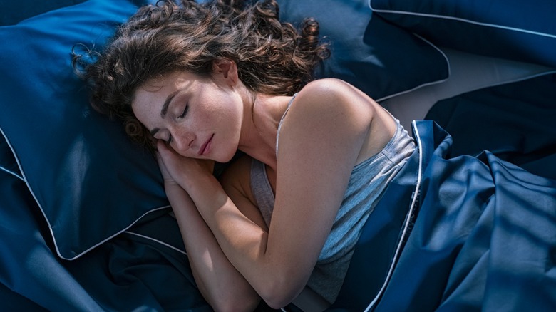 Young woman dreaming in bed