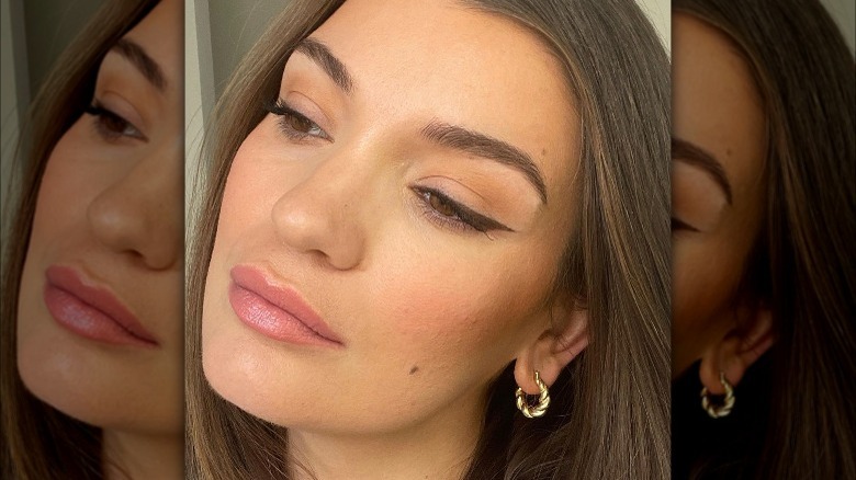 A sharp brown eyeliner with nude lips