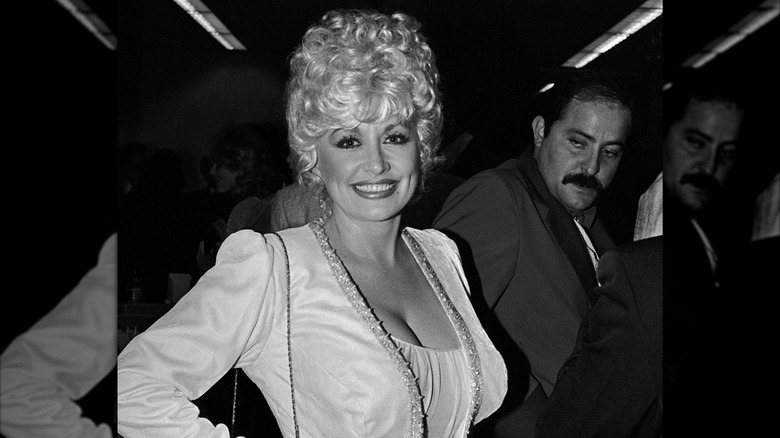 Dolly Parton in 1984 wearing a white outfit.