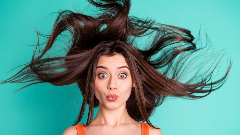 woman with voluminous hair in the air